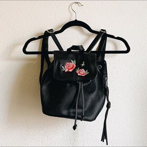 Embroidered rose mini backpack.